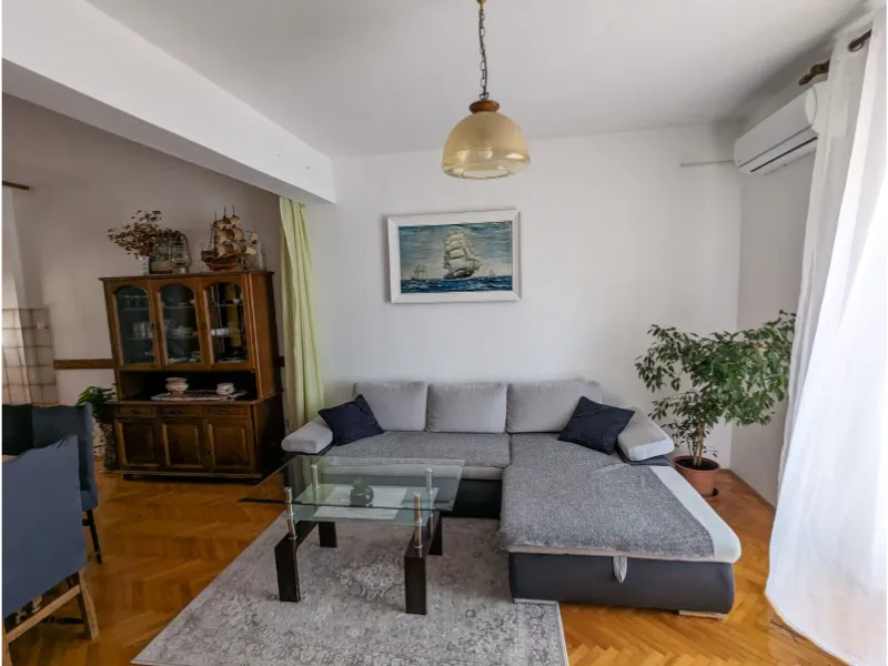 Photo of living room with couch and dining table